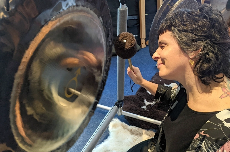 Cristina playing a Gong